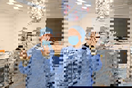 Two people waving hands